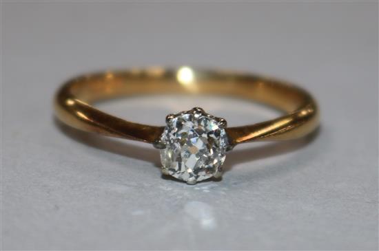 A 22ct gold and solitaire diamond ring, size R.